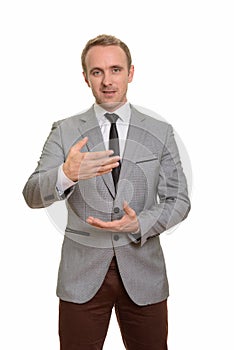 Handsome Caucasian businessman explaining isolated against white background