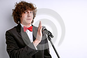 handsome caucasian frightened man on a stage with microphone