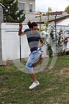 Handsome caucasian guy is working out in the nature.  Gymnastics, healthy lifestyle concept.