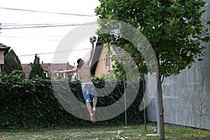 Handsome caucasian guy is working out in the nature.  Gymnastics, healthy lifestyle concept.