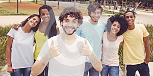 Handsome caucasian hipster guy with group of friends in retro lo