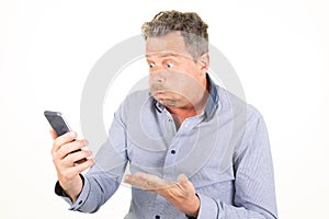 Handsome caucasian man angry frustrated sad furious with phone over white background