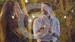 Handsome Caucasian man asking girlfriend for marriage and giving wedding ring. Portrait of happy loving fiancee