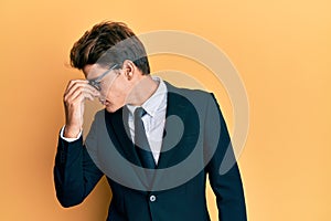 Handsome caucasian man wearing business suit and tie tired rubbing nose and eyes feeling fatigue and headache