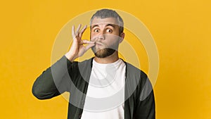 Handsome caucasian man zipping his mouth with gesture
