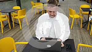 Handsome Caucasian student using laptop computer watching distance online learning seminar class, remote university