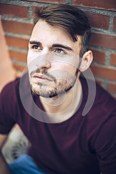 Handsome caucasian young man in casual clothes in urban environment