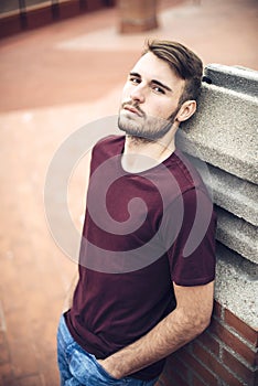 Handsome caucasian young man in casual clothes in urban environment