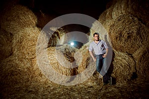 Handsome caucasian young man in the hay barn