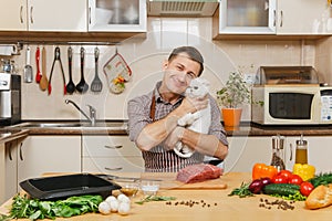 Handsome caucasian young man, sitting at table. Healthy lifestyle. Cooking at home. Prepare food.