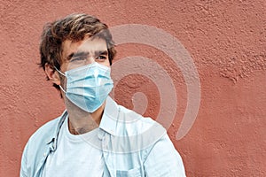 Handsome caucasian young man wearing a mask against coronavirus. New normality portrait