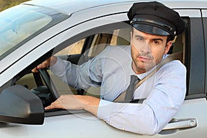 Handsome chauffeur looking at camera