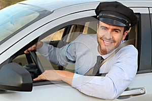 Handsome chauffeur smiling at camera