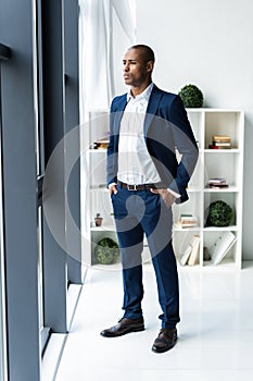 Handsome cheerful african american executive business man at the workspace office.