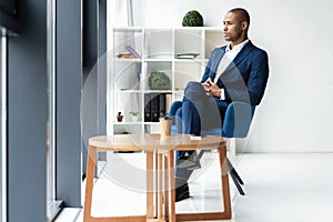 Handsome cheerful african american executive business man at the workspace office.