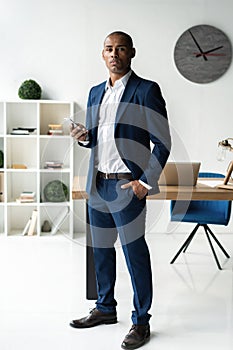 Handsome cheerful african american executive business man at the workspace office.