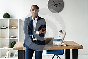 Handsome cheerful african american executive business man at the workspace office.