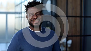 Handsome cheerful african american executive business man at the workspace office