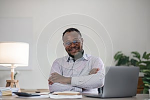 Handsome cheerful african american executive business man at the workspace office