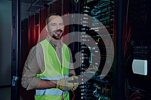 handsome cheerful technician in safety vest