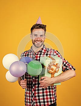 Handsome cheerful young man with smile having fun on party. people and joy. birthday and celebration concept. real