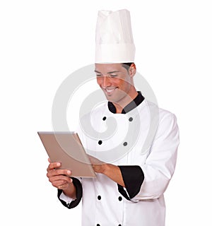 Handsome chef guy using his tablet pc