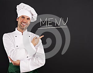 Handsome chef showing menu