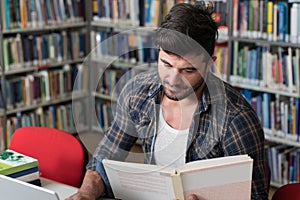 Handsome College Student in a Library