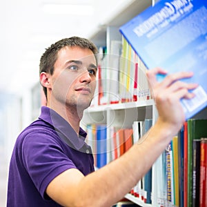 Handsome college student in library