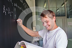 Handsome college student solving a math problem