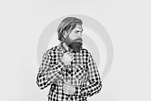 handsome confident man has perfect hairstyle. bearded man in checkered shirt. male beauty concept. Portrait of bearded
