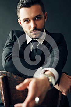 Handsome confident man portrait on dark background