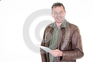 Handsome confident middle aged man in leather vest holding generic digital tablet and smiling broadly using online application