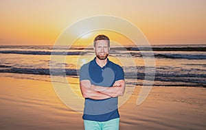 Handsome and confident. Outdoor portrait of happy young american guy on the beach. Handsome man wearing casual clothes
