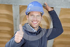 Handsome construction worker showing thumbs up