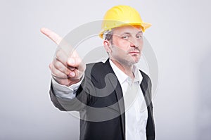 Handsome contractor wearing helmet gesturing denial