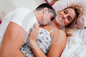 Handsome couple in bed being sensual