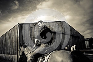 Handsome cowboy, horse rider on saddle, horseback adn boots