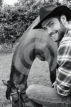 Handsome cowboy, horse rider on saddle, horseback adn boots