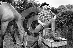 Handsome cowboy, horse rider on saddle, horseback adn boots