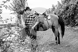 Handsome cowboy, horse rider on saddle, horseback adn boots