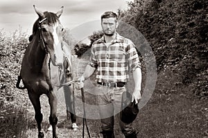 Handsome cowboy, horse rider on saddle, horseback adn boots