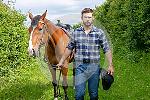 Handsome cowboy, horse rider on saddle, horseback adn boots