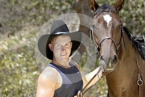 Handsome cowboy portrait with his horse.