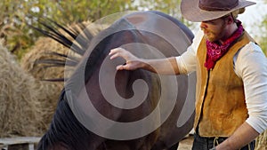 Handsome cowboy shows his horse to beautiful woman