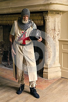 Handsome crusader in front of fireplace