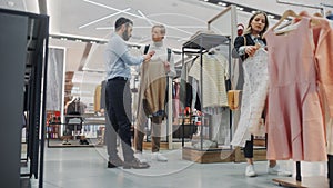 Handsome Customer Shopping in Clothing Store, Retail Sales Assistant Helps with Advice. Diverse