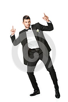 handsome dancing young groom pointing up
