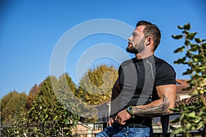 Handsome dark haired young man looking out on the view