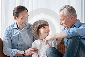 Handsome delighted grandfather looking at his grandson